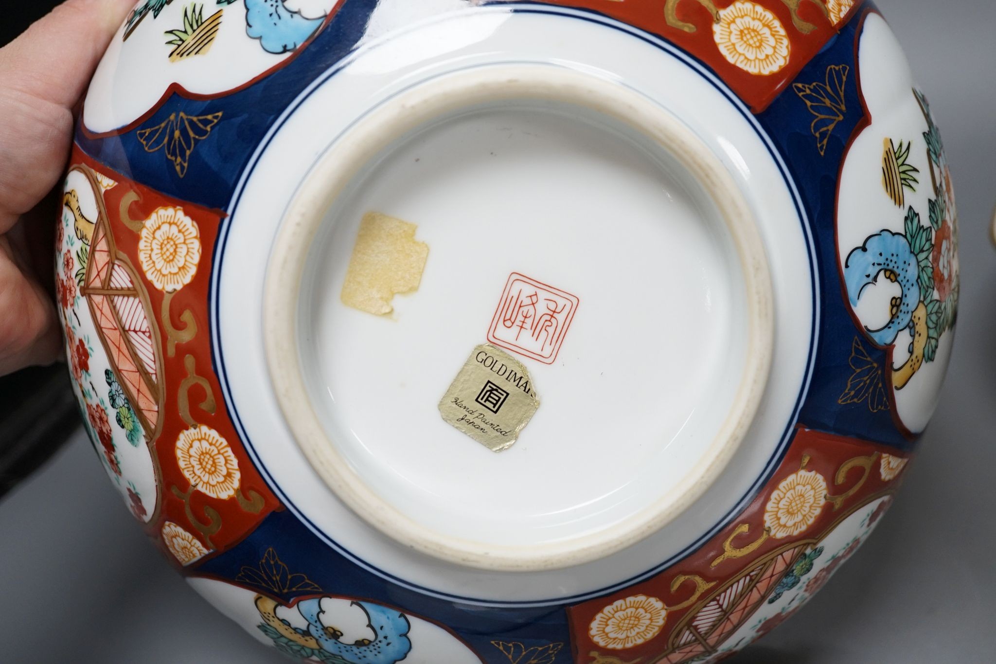 A Royal Crown Derby Imari bowl and two plates and another bowl, 25cm
